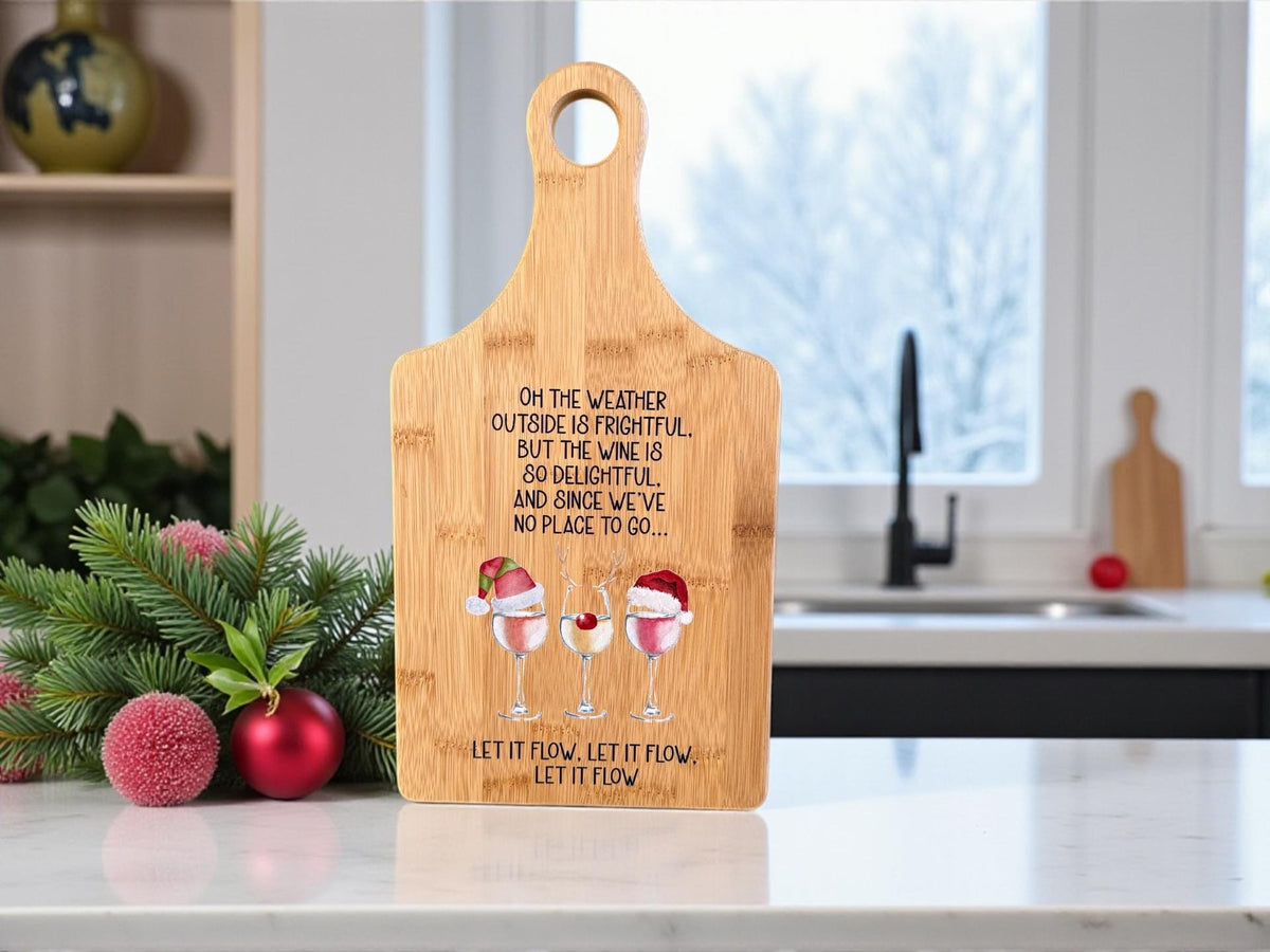 Decorative bamboo paddle board with Christmas wine-themed artwork and the words “Let It Flow Christmas Wine”.