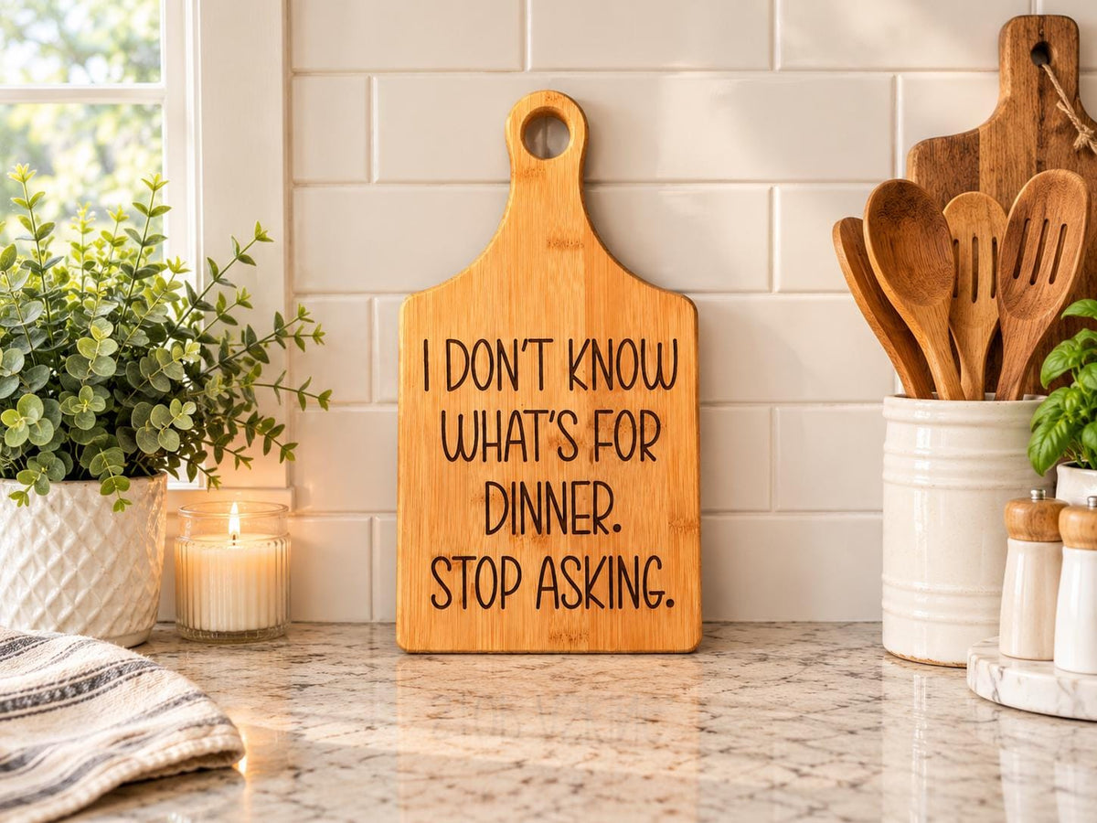 Decorative bamboo paddle board with humorous lettering and the words “I Don't Know What's for Dinner, Stop Asking”.
