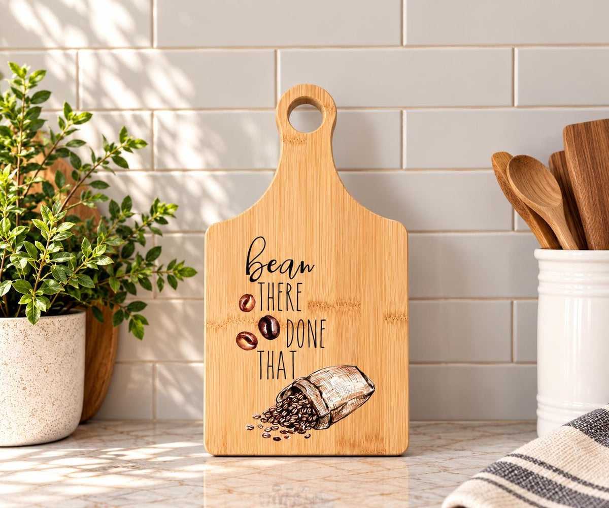 Decorative bamboo paddle board with coffee beans and the words “Bean There, Done That”.