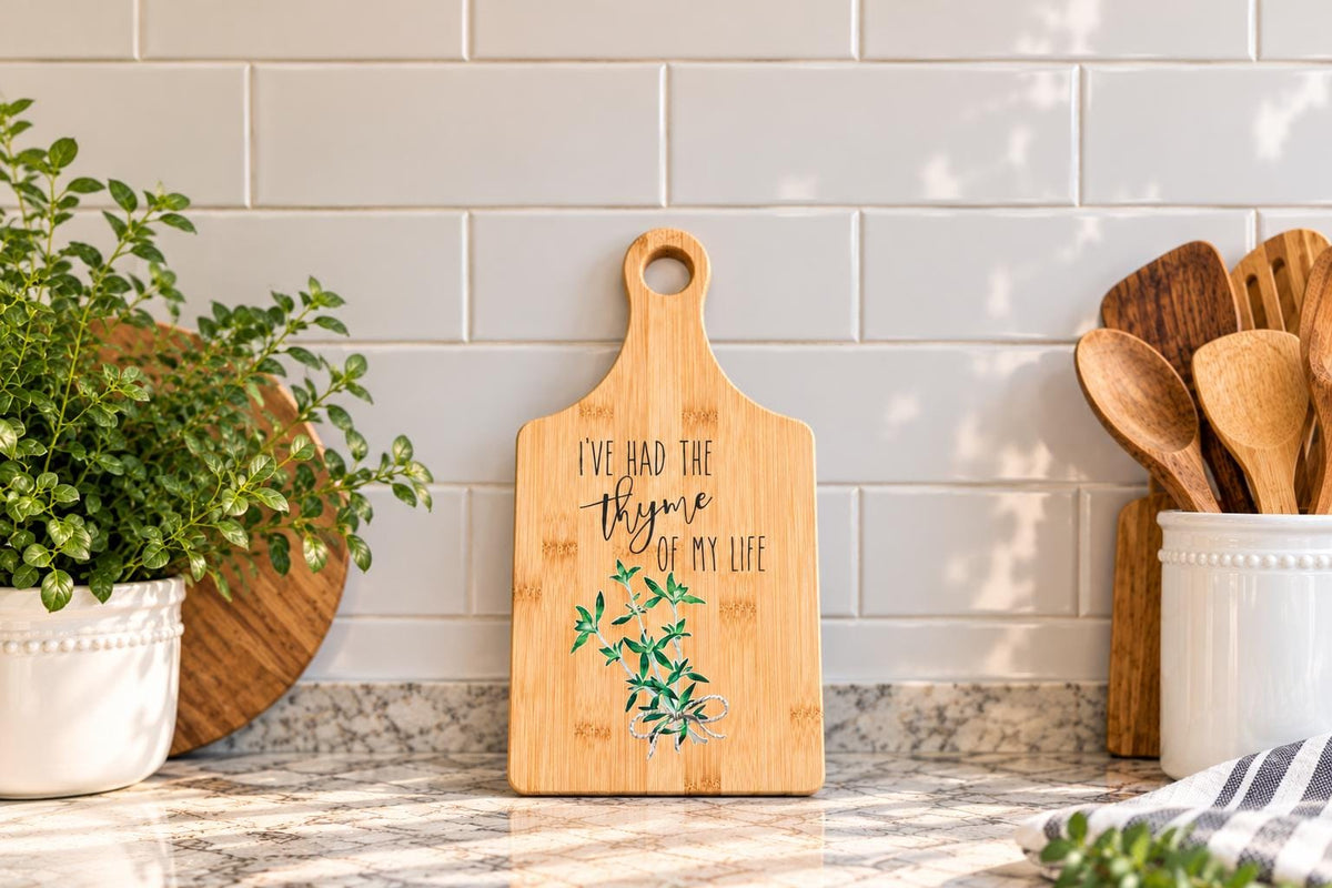 Decorative bamboo paddle board with thyme herb sprig and the words “I've Had the Thyme of My Life”.