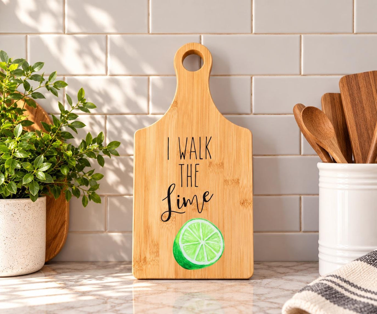 Decorative bamboo paddle board with lime illustration and the words “I Walk the Lime”.