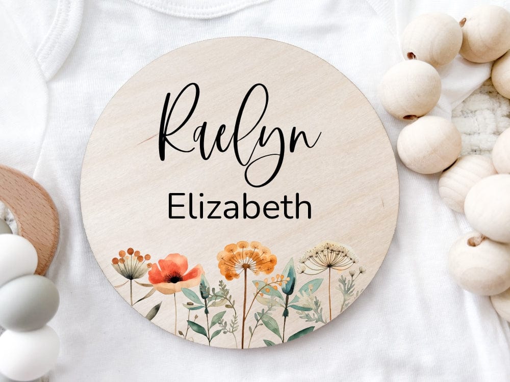 wooden baby name announcement sign with flowers at bottom. Comes with first name in cursive and middle name in non cursive fonts