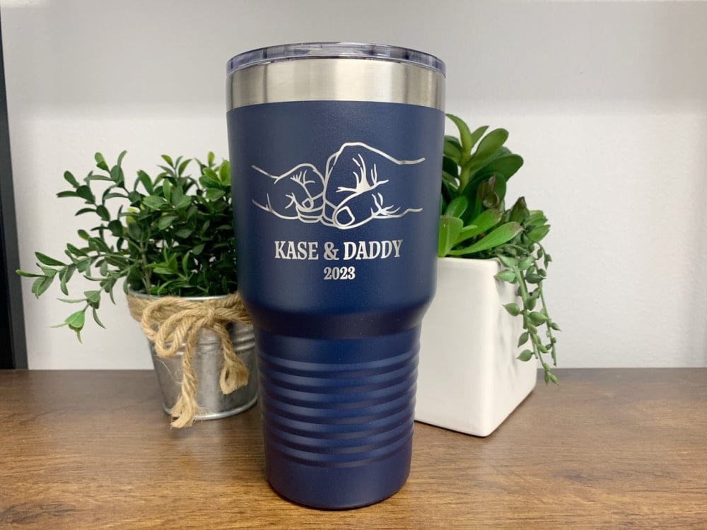 30oz navy blue tumbler featuring an engraved fist bump design, personalized with names of a child and dad, along with the year.