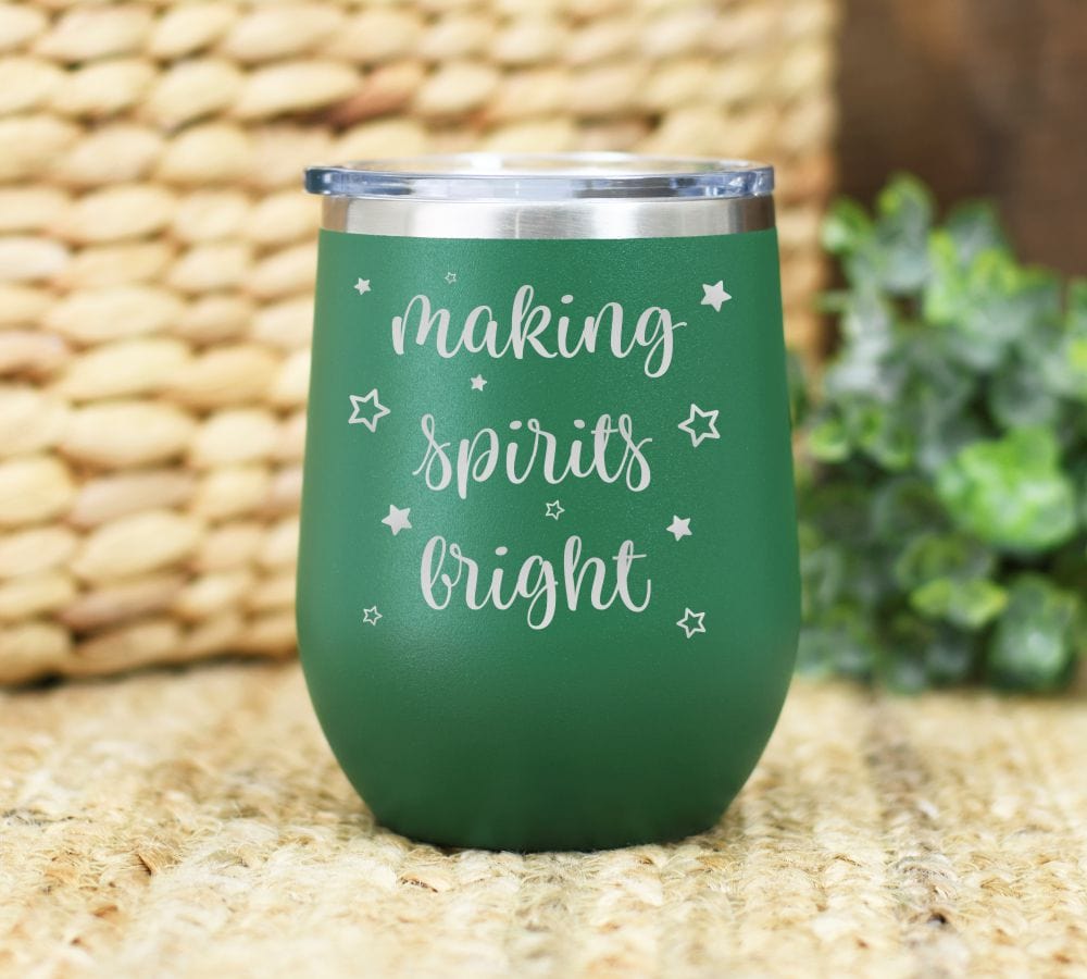 12oz christmas wine tumbler laser engraved with making spirits bright and stars. green tumbler shown.