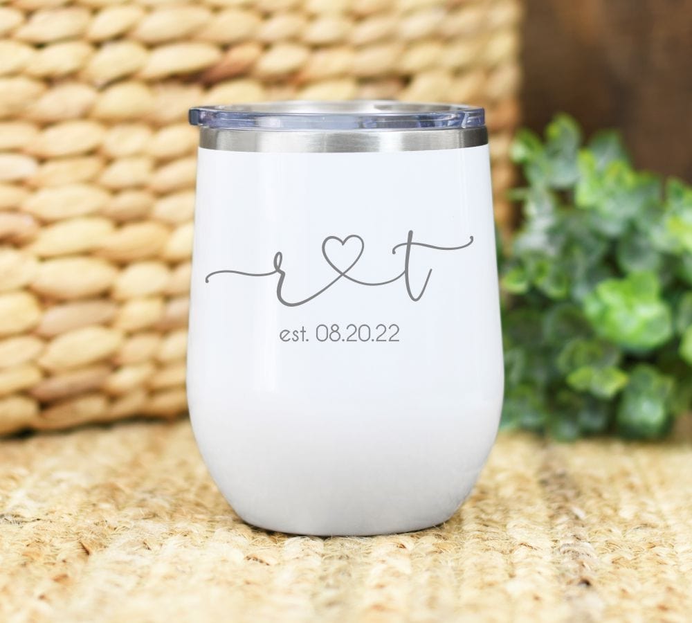 12oz wine tumbler laser engraved with two initials (lower case letters) connected with a heart and below an est. date.