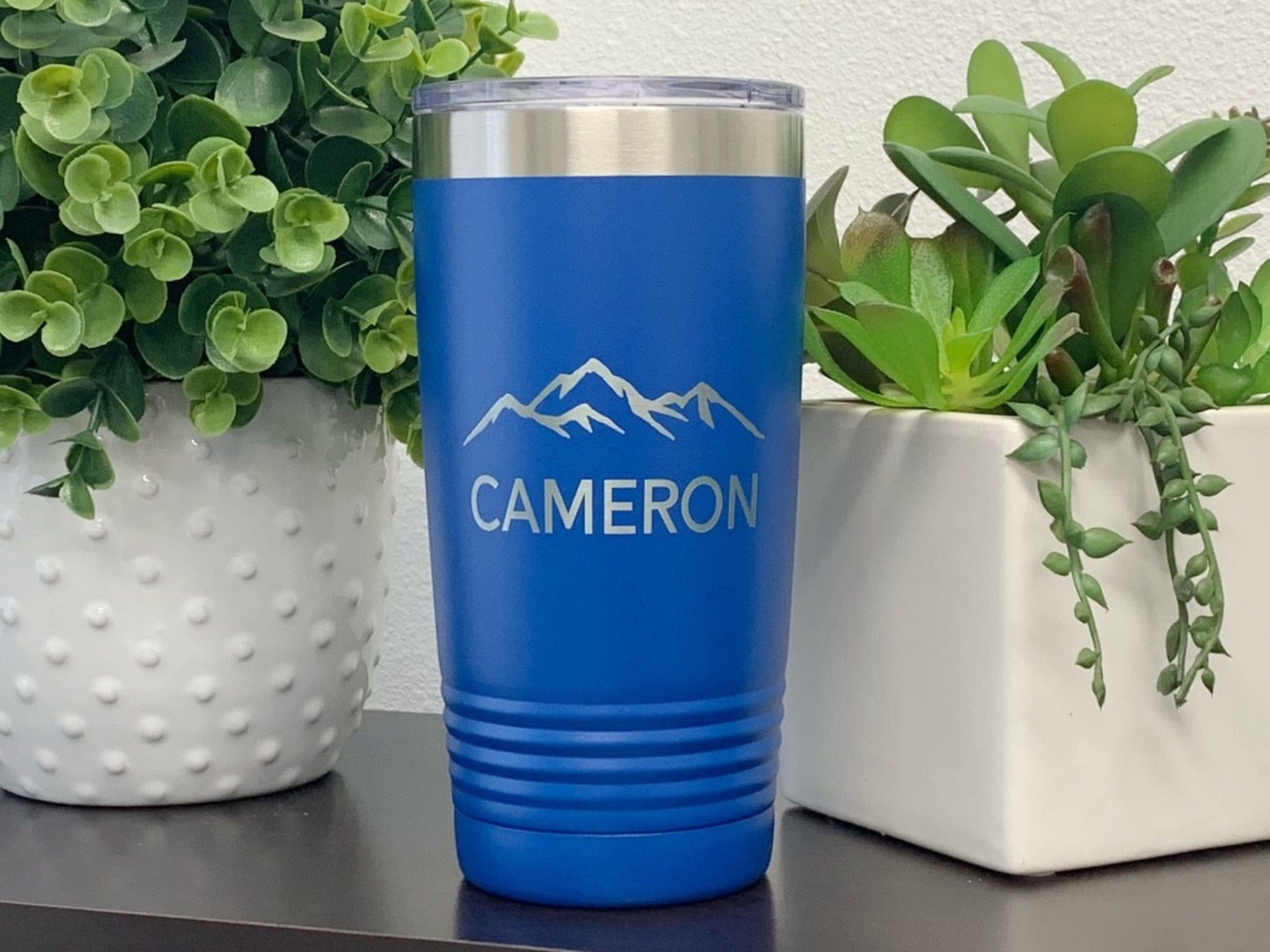 https://www.runwildengraving.com/cdn/shop/products/20jds-20-oz-name-personalized-20-oz-tumbler-with-mountain-34540263964839.jpg?v=1681054397